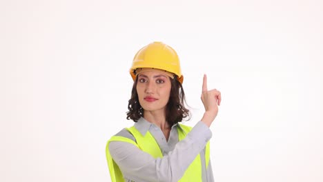 woman engineer in hard hat and safety vest making hand gestures