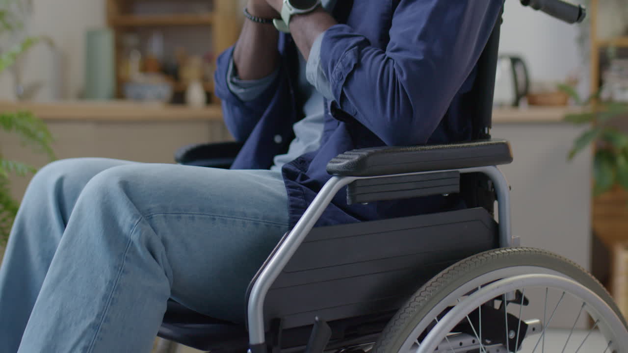 African American Man in Wheelchair Praying at Home