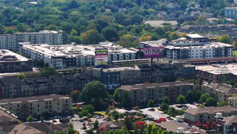 Tracking-of-subway-train-unit-driving-on-elevated-track-along-buildings-in-urban-borough