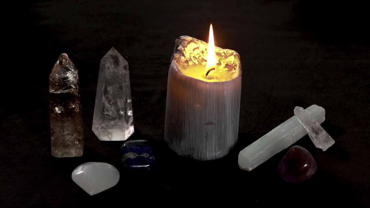 Crystals and candle burning during a candle magick ritual
