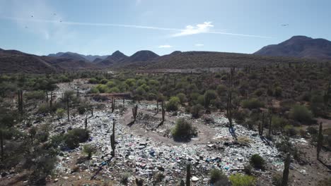 Trash-Dispersed-Among-the-Desert-Terrain-of-Mulege,-Baja-California-Sur,-Mexico---Aerial-Drone-Shot