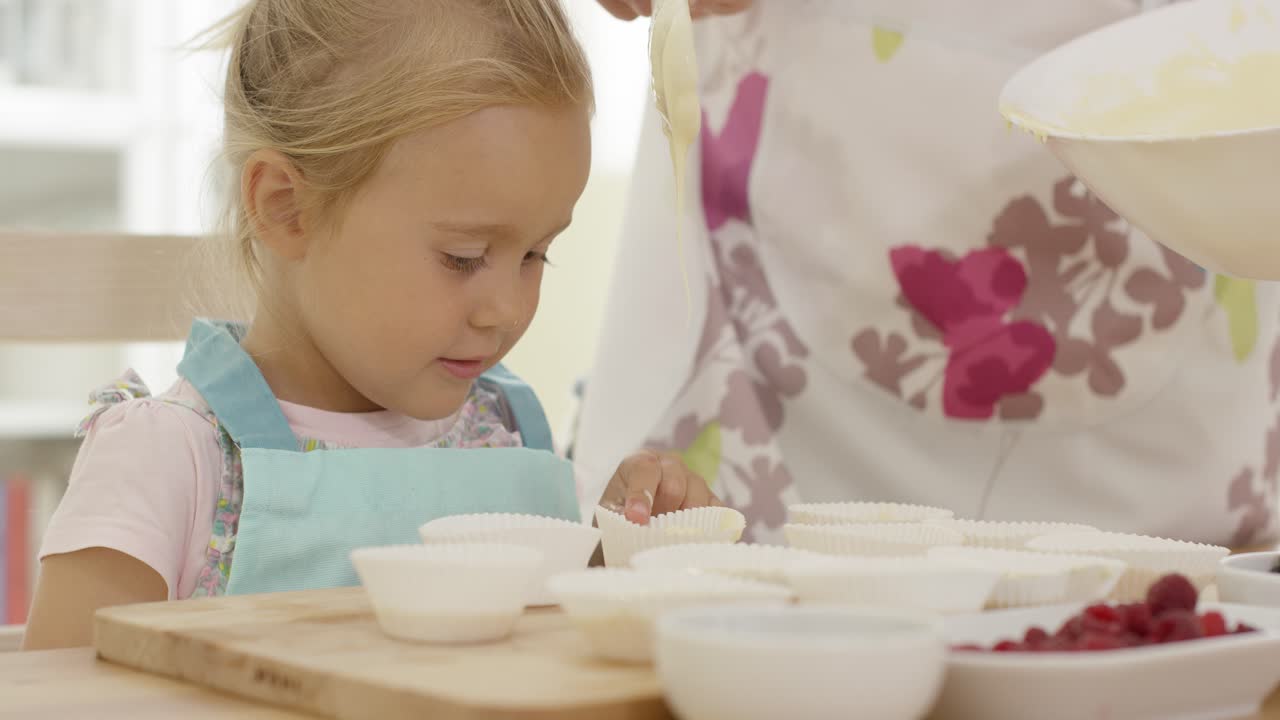 Happy little girl with empty muffin holders