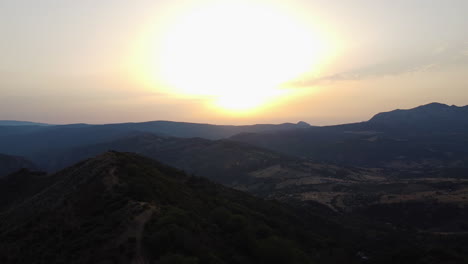 a drone flies over the mountains in pico de los reales in estepona spain
