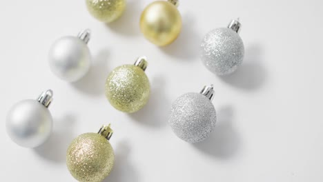 Video-of-christmas-baubles-and-copy-space-on-white-background