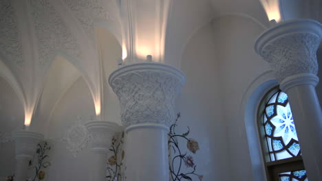 ornate white interior with stained glass window