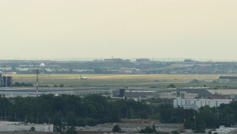 Static-Wide-shot-of-Airplane-taking-off-from-Toronto-Airport-during-sunny-day