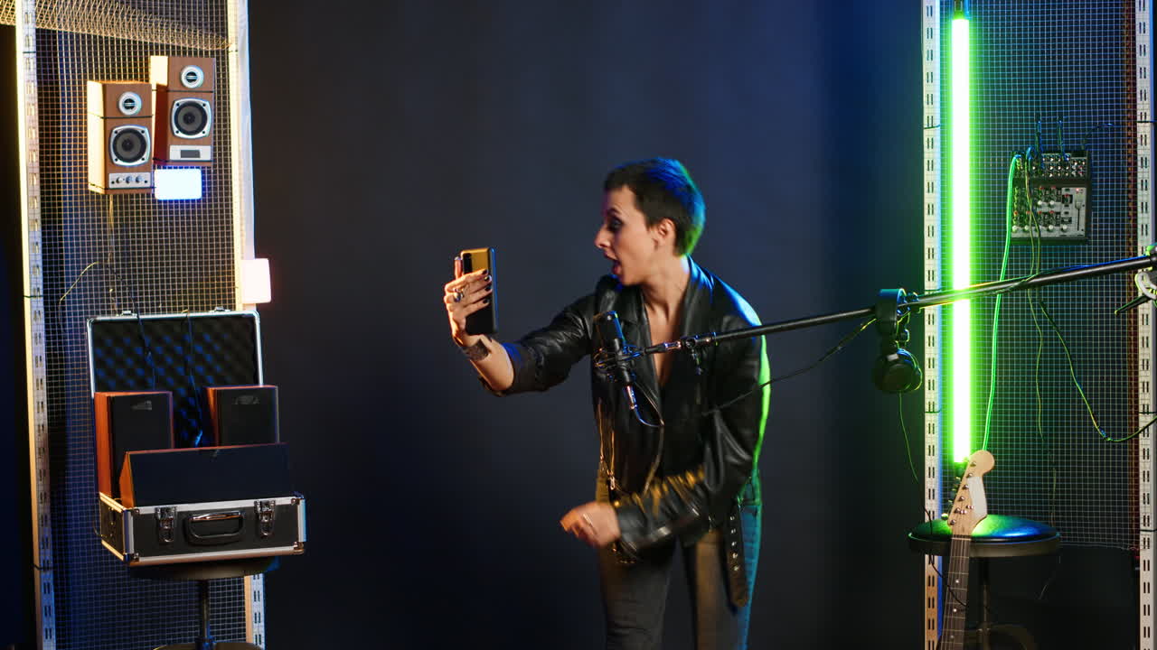 Woman taking selfie in music studio