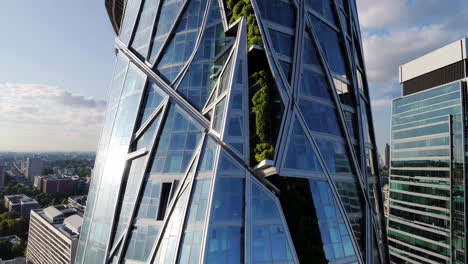 modern skyscraper with green facade