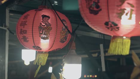 Chinese-lanterns-with-funny-kids-and-tassels-in-cafe-at-dusk