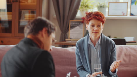 young woman talking with psychologist on therapy session