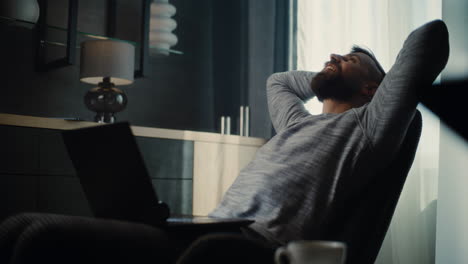 happy stock exchange trader celebrating after making successful trading deal, monitoring real-time stocks and exchange market charts on laptop. excited businessman working in financial agency office.