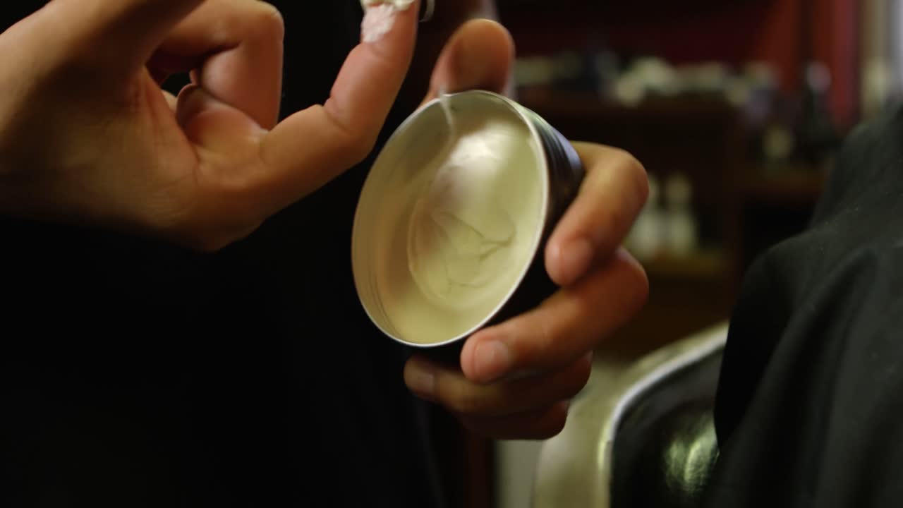 Barber taking out hair wax from wax can at barber shop 4k