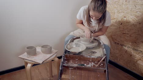 woman working on pottery wheel