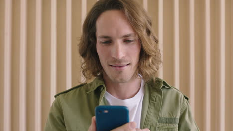 close-up-portrait-of-handsome-young-caucasian-man-texting-browsing-online-using-smartphone-mobile-technology-enjoying-digital-communication