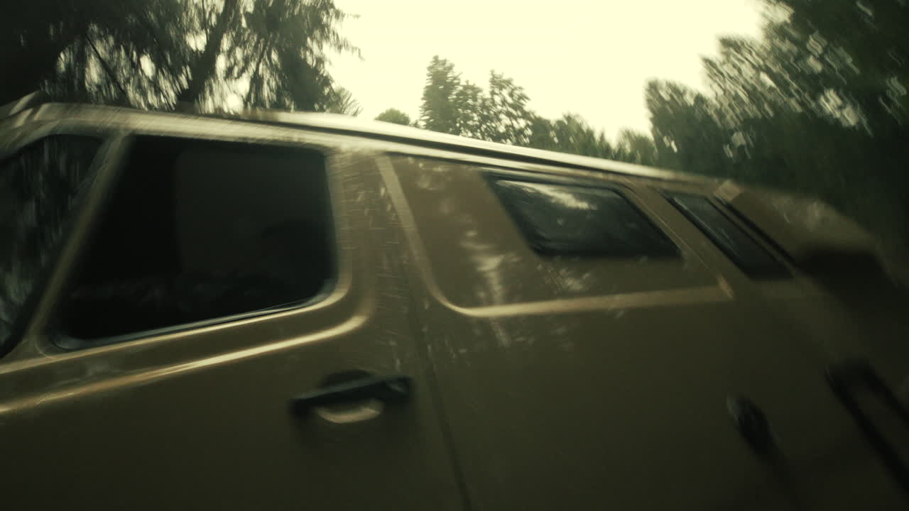 Van Driving Through a Forest