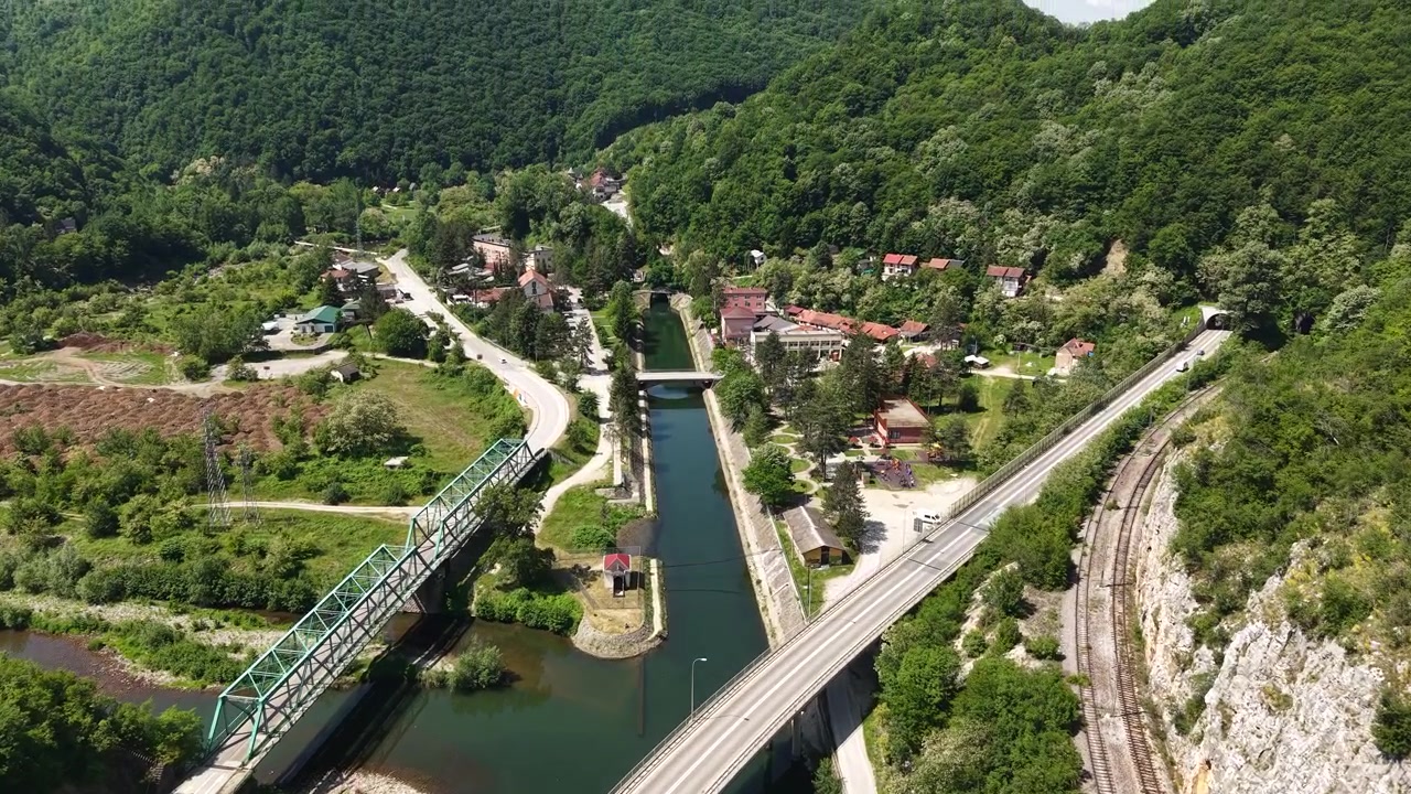 Revealing Drone Shot of Ovcar Banja, Serbia. Road Traffic, Railway and Buildings by West Morava River