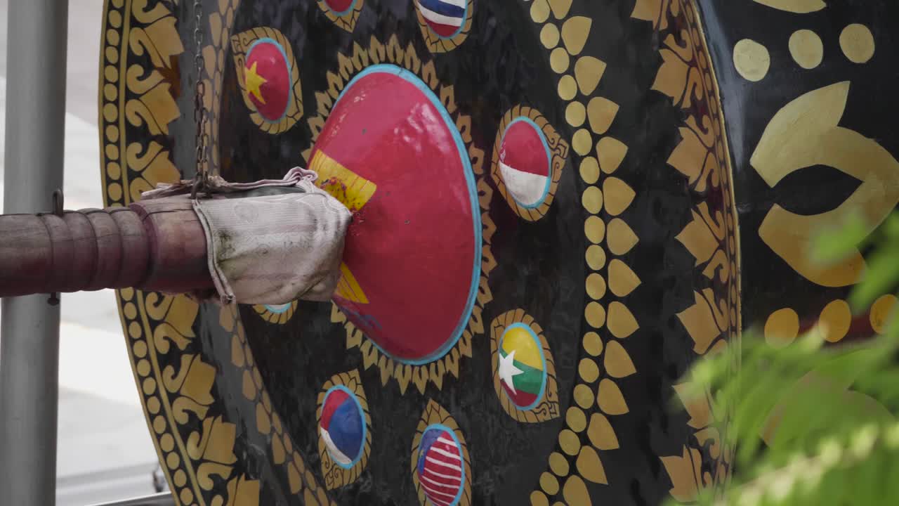 Big Swinging Mallet Hits Big Nipple Gong at Buddhist Temple.