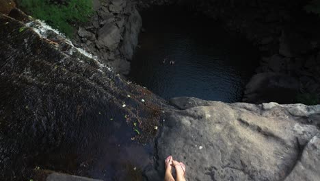 aerial view of female hiker sitting on top of ozone falls tennessee natural area usa