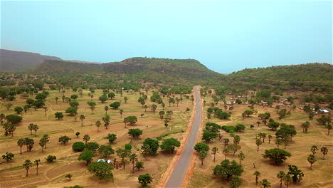 rural village road in nigeria, west africa - aerial reveal