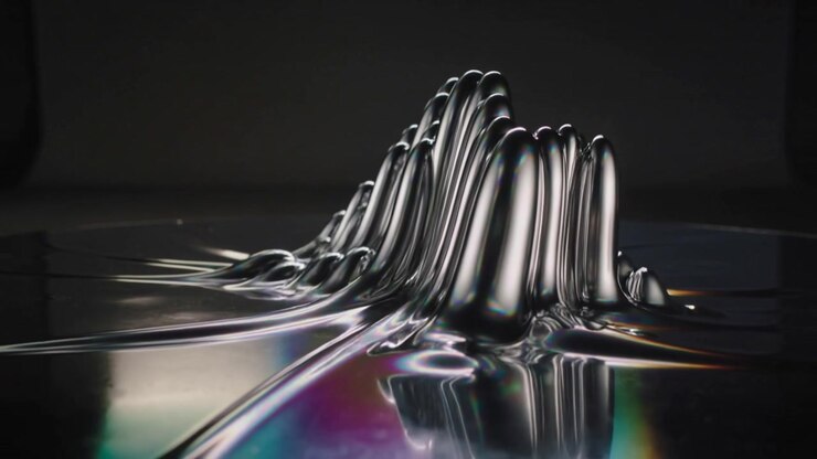 Forming viscous metallic liquid creating spikes and ridges on reflective tray with colored lights