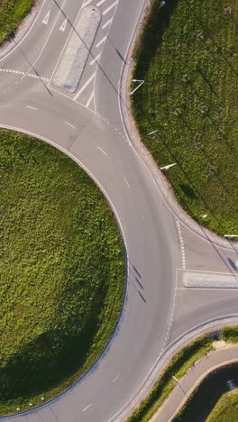 vertical view of vehicles circulating on katlakalns roundabout in latvia. aerial topdown shot