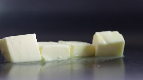 loop of butter melting on heated non stick pan.