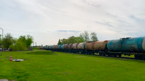 Static-shot-of-long-line-of-freight-train-cisterns-transport-diesel-fuel,-Latvia