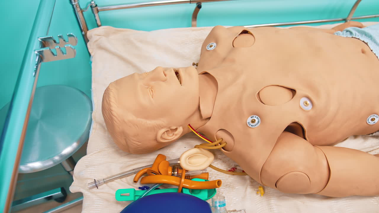 Dummy model for teaching medical practice. Mannequin doll of a man lying in hospital bed in studying room of medical university.