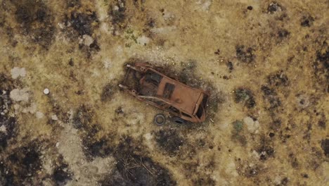 dramatic abandoned damaged rusty car in the desert aerial view