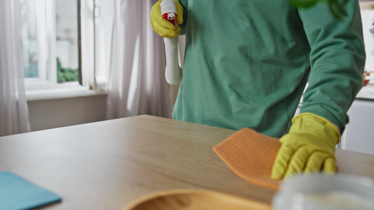 Cleaning service guy hands wiping kitchen surface home closeup. Domestic routine