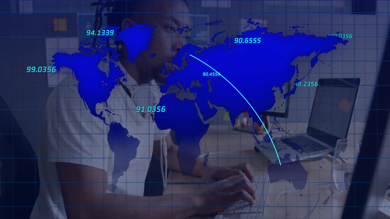 IT professional typing at tech office desk, displaying semi-transparent world map with numeric data