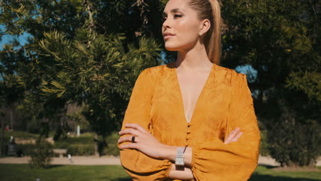 stylish young woman with arms crossed outdoors.