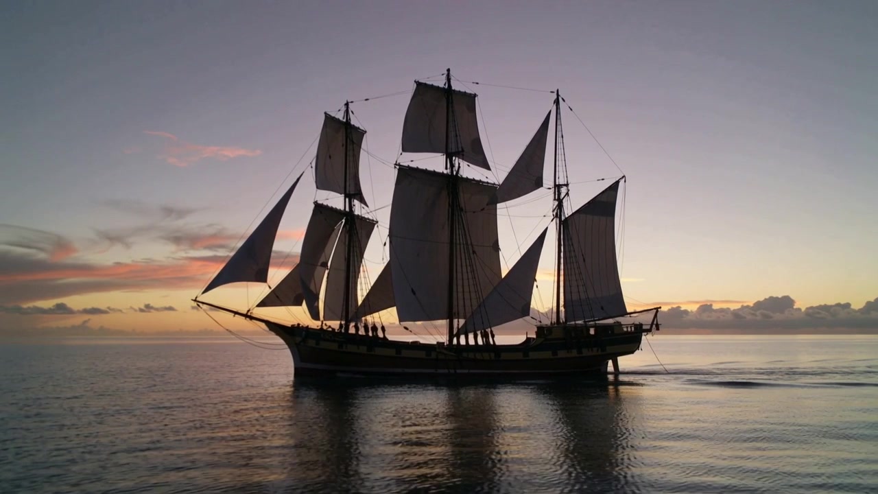 Vento leggero che gonfia le vele, nave a tre alberi che si muove a destra in mare, equipaggio in cappotti scuri che regola le sartie