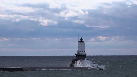 a lighthouse stands in lake michigan near ludington michigan