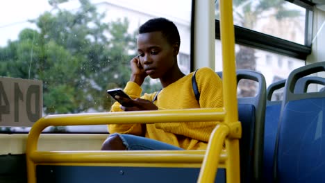 woman using mobile phone while travelling in bus 4k