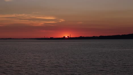 Timelapse of sunset over Montevideo’s Cerro Bay, with the sun setting behind the old Swift meatpacking plant on a calm winter afternoon during the golden hour