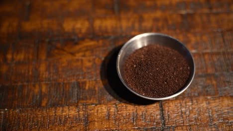 Rack-focus-on-coffee-grounds-in-a-ramekin