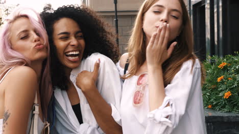 three happy friends posing outdoors