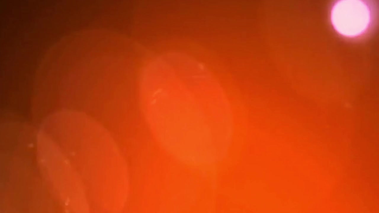 Warm Light Leak and Lens Flare Transition with Bright Flash