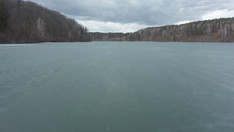 AERIAL:-Low-Flight-Above-Frozen-Lake-with-Blue-Colour-Ice