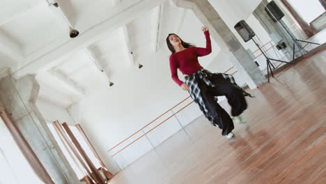 young woman dancing in a bright dance studio