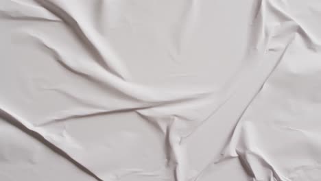 Video-of-close-up-of-white-creased-fabric-with-copy-space