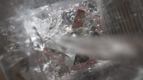 Water-pouring-into-empty-blender,-SLOWMO-overhead-close-up