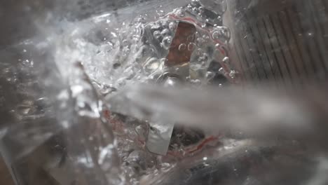 water pouring into empty blender, slowmo overhead close up