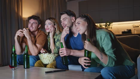 carefree friends enjoy tv film sitting cozy home couch. people discussing show