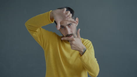 man framing a photo