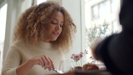 young couple enjoying meal on date in city restaurant