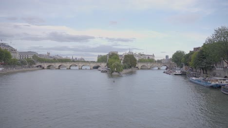 centered wide shot of the seine river in paris, with bridges and buildings in the distance