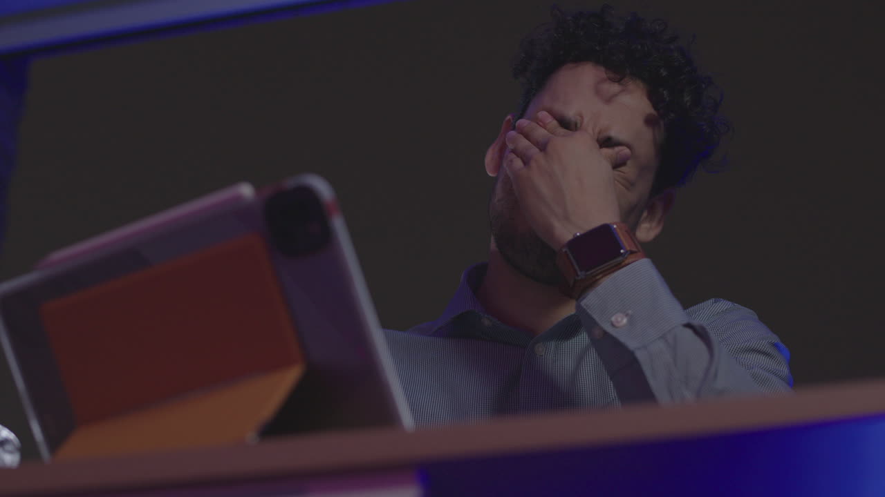 Workaholic businessman entrepreneur burnout at work late night feeling tired and exhausted