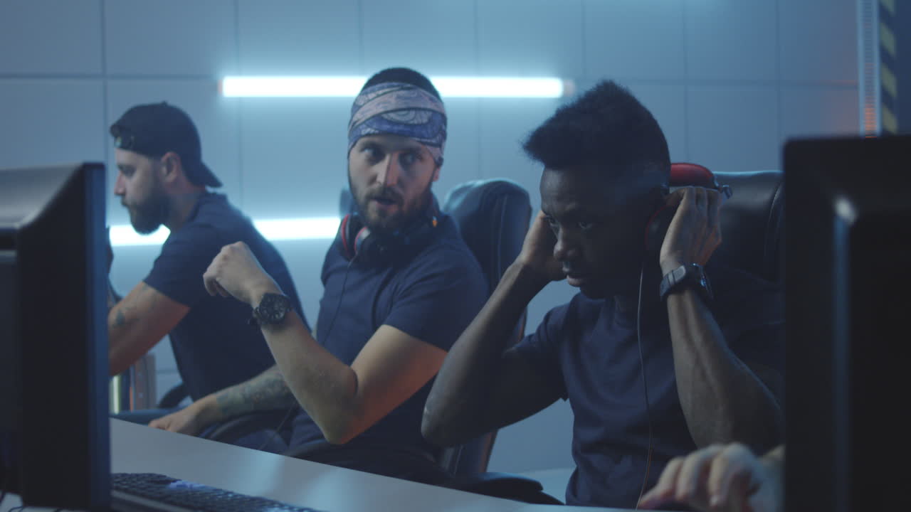 Gaming Team Relaxing after Match Medium Shot of Members of a Gaming Team Talking and Relaxing after a Match